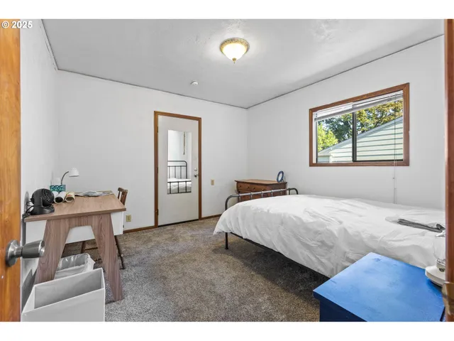 a bed room with a bed and a chair