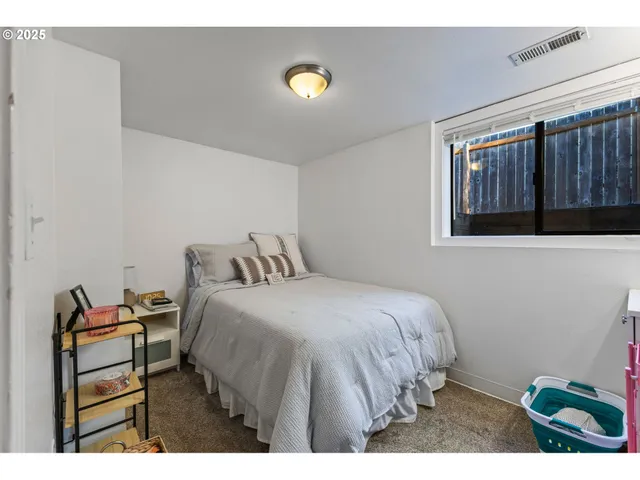 a bedroom with a bed and a desk