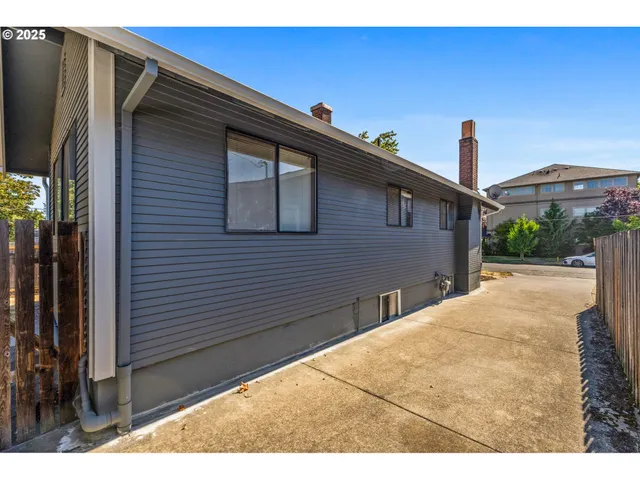 a front view of a house with a yard covered in snow