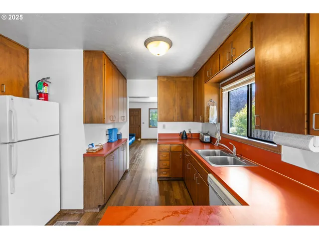a kitchen with a refrigerator and a sink