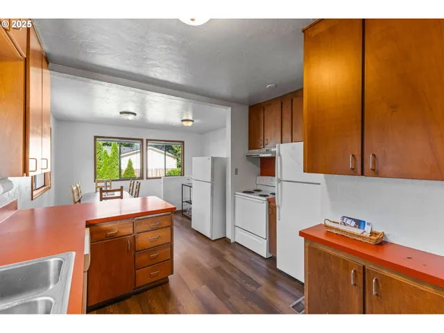 a kitchen with kitchen island and wooden cabinets