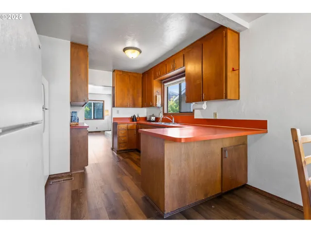 a kitchen with a sink cabinets and window
