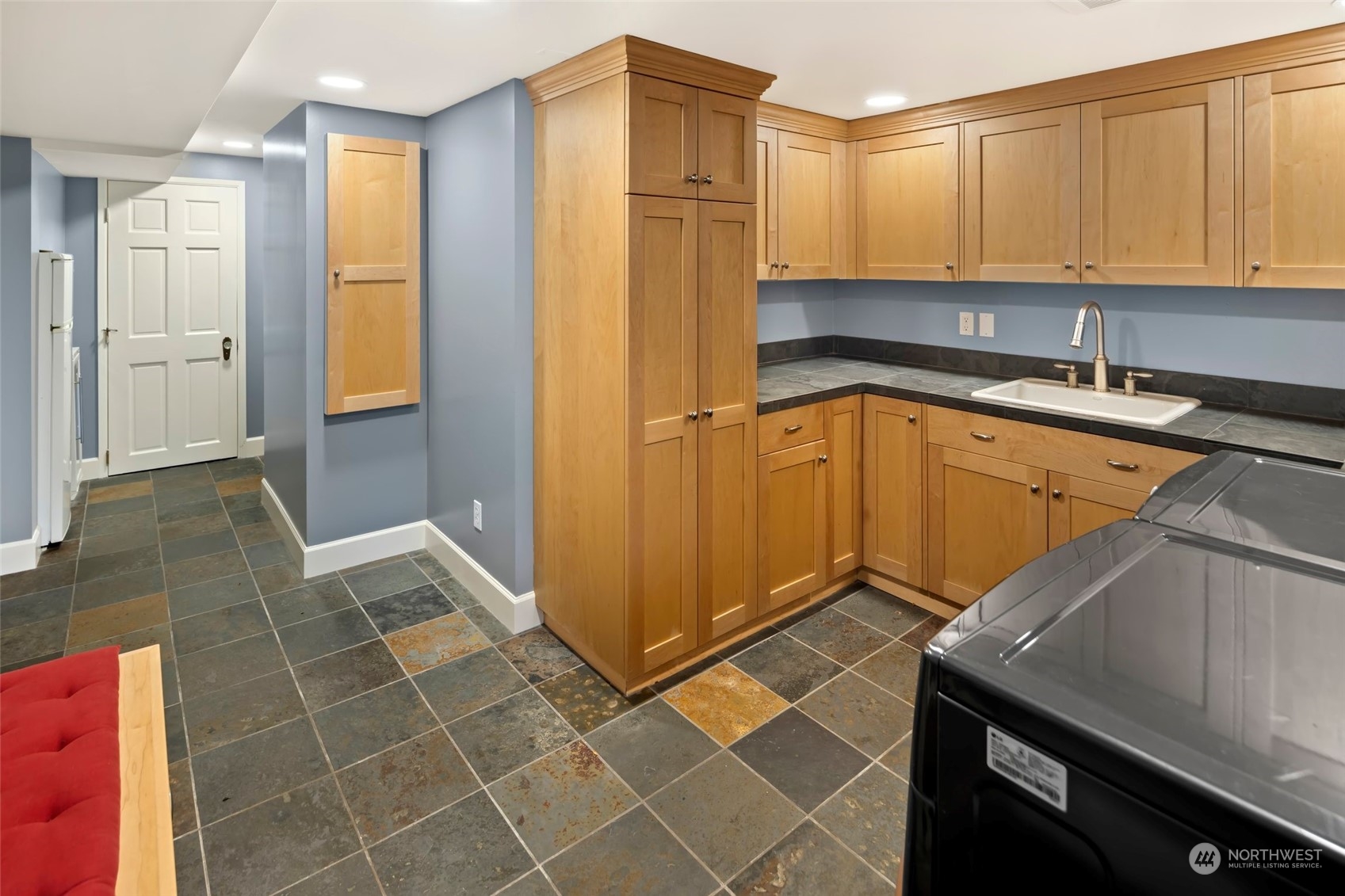 2226 12th Avenue East Seattle, WA 98102 - Photo 28 of 37 a kitchen with a sink a refrigerator and cabinets