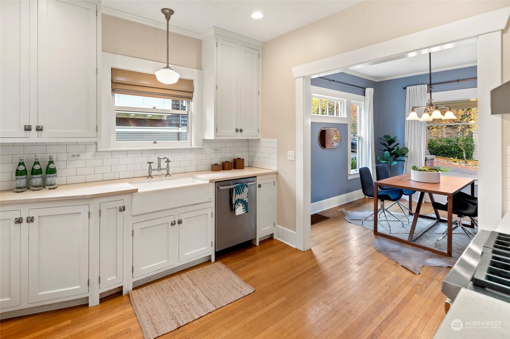 2226 12th Avenue East Seattle, WA 98102 - Photo 9 of 37 a large white kitchen with a window wooden floor and stainless steel appliances