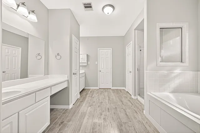 a bathroom with a bathtub and a sink