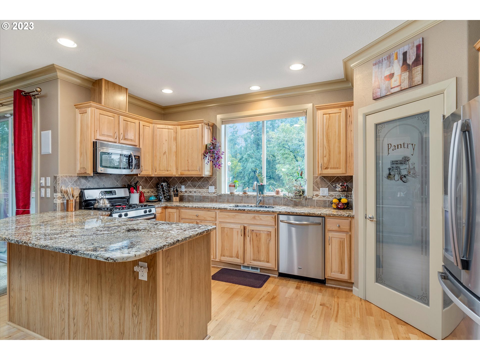 16472 Southeast Siri Loop Damascus, OR 97089 - Photo 11 of 41 a kitchen with stainless steel appliances granite countertop a sink a stove and a refrigerator