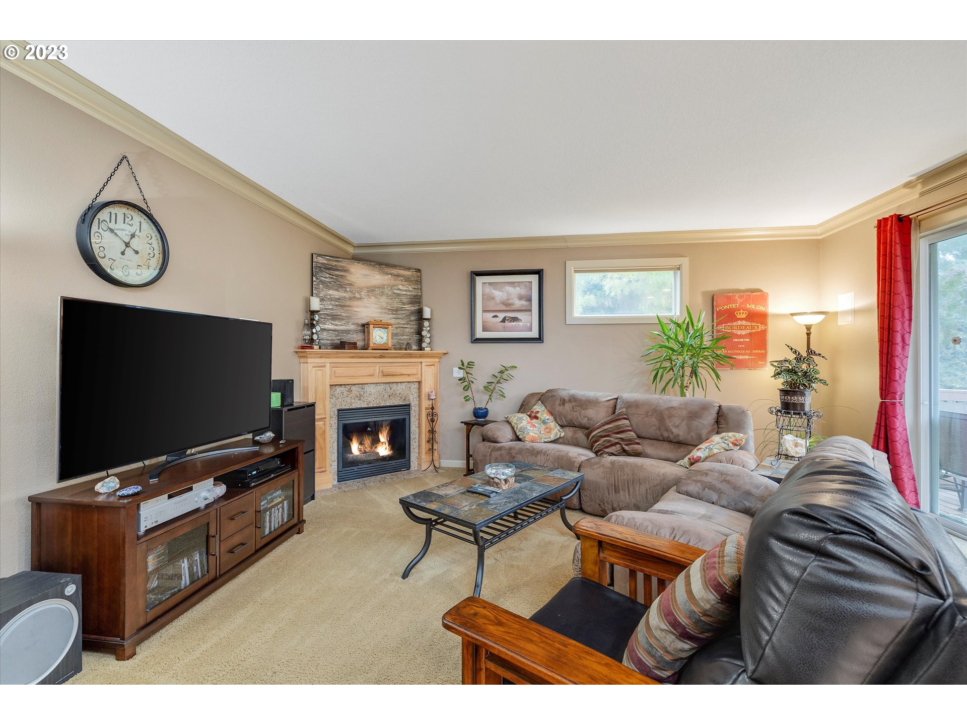 16472 Southeast Siri Loop Damascus, OR 97089 - Photo 15 of 41 a living room with furniture a flat screen tv and a fireplace