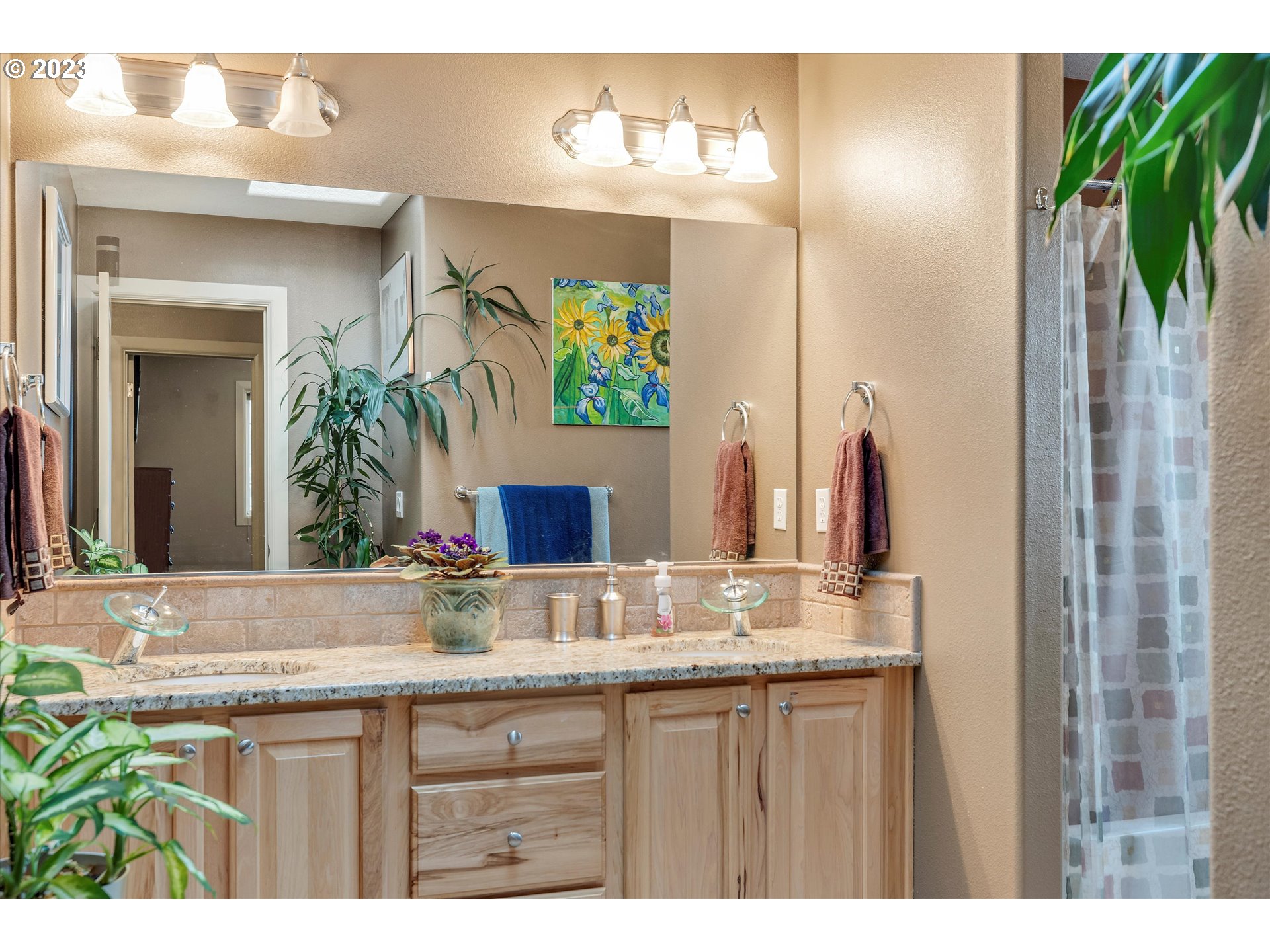 16472 Southeast Siri Loop Damascus, OR 97089 - Photo 23 of 41 a bathroom with a granite countertop sink and a mirror
