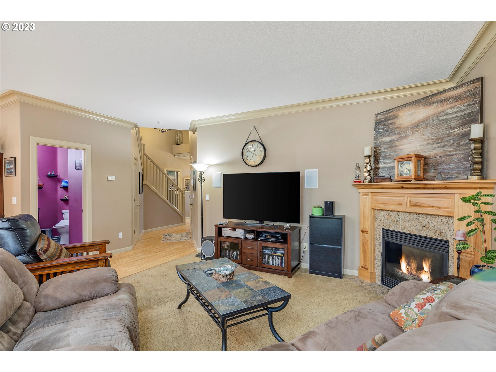 16472 Southeast Siri Loop Damascus, OR 97089 - Photo 27 of 41 a living room with furniture a flat screen tv and a fireplace