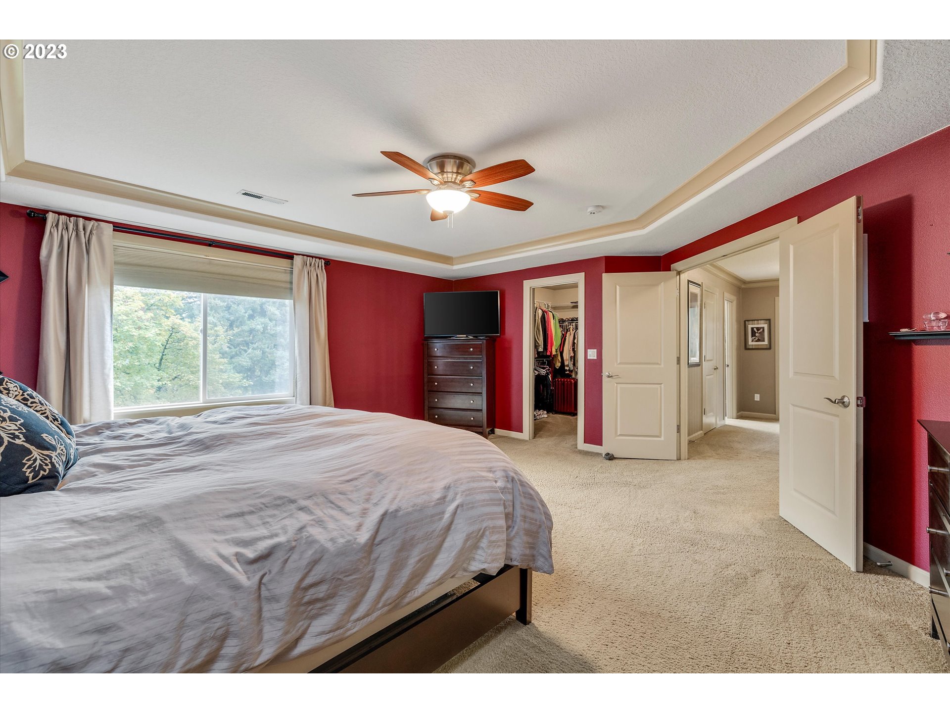 16472 Southeast Siri Loop Damascus, OR 97089 - Photo 30 of 41 a bedroom with a large bed and a chandelier