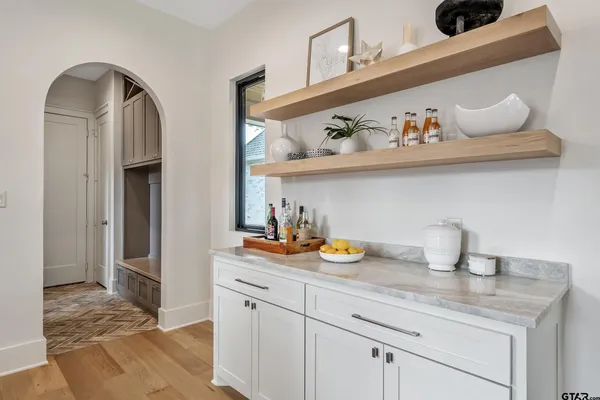 a spacious bedroom with a bed a table and large window