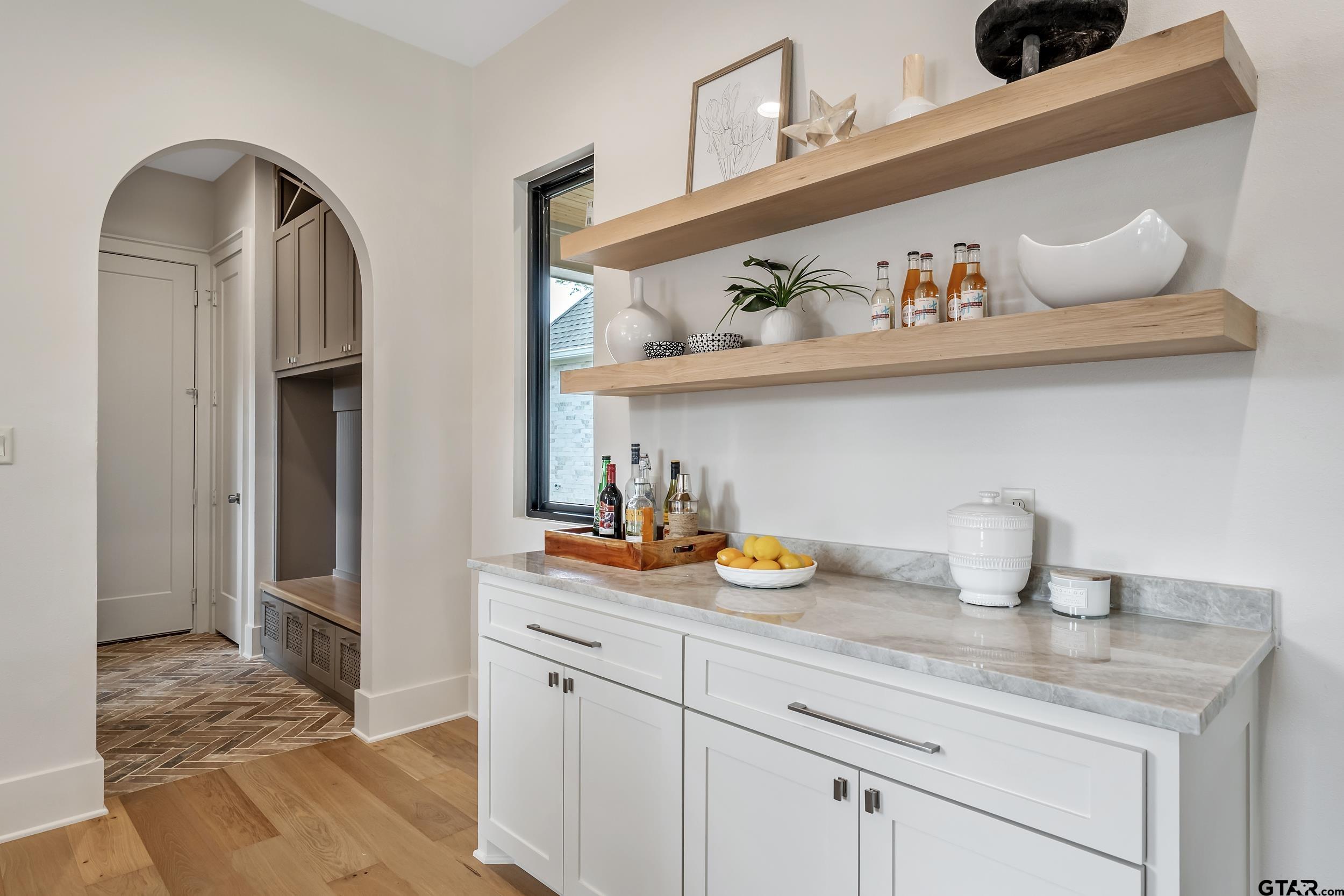 1409 Canopy Cv Court Tyler, TX 75703 - Photo 14 of 40 a kitchen with a sink a stove and cabinets