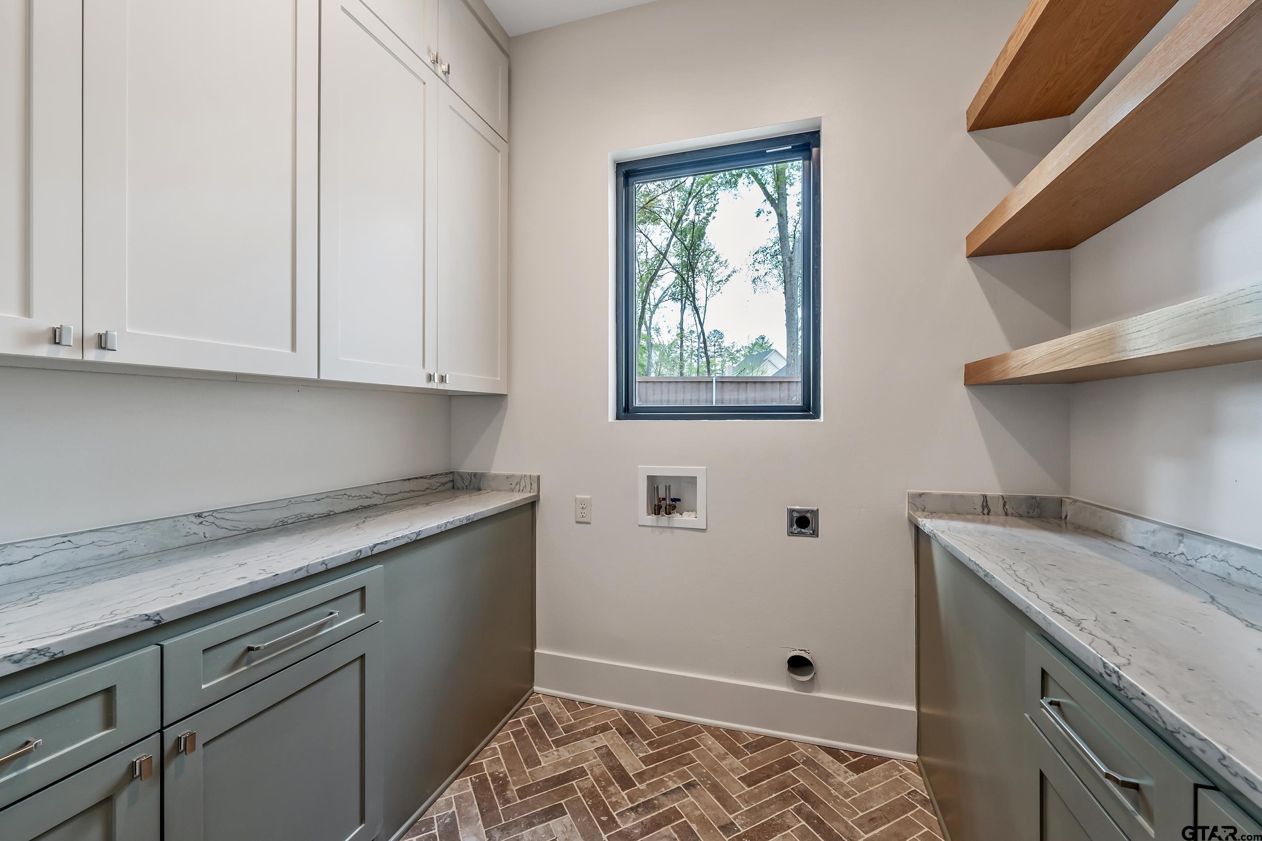 1409 Canopy Cv Court Tyler, TX 75703 - Photo 15 of 40 a kitchen with stainless steel appliances granite countertop a sink a stove and white cabinets with wooden floor