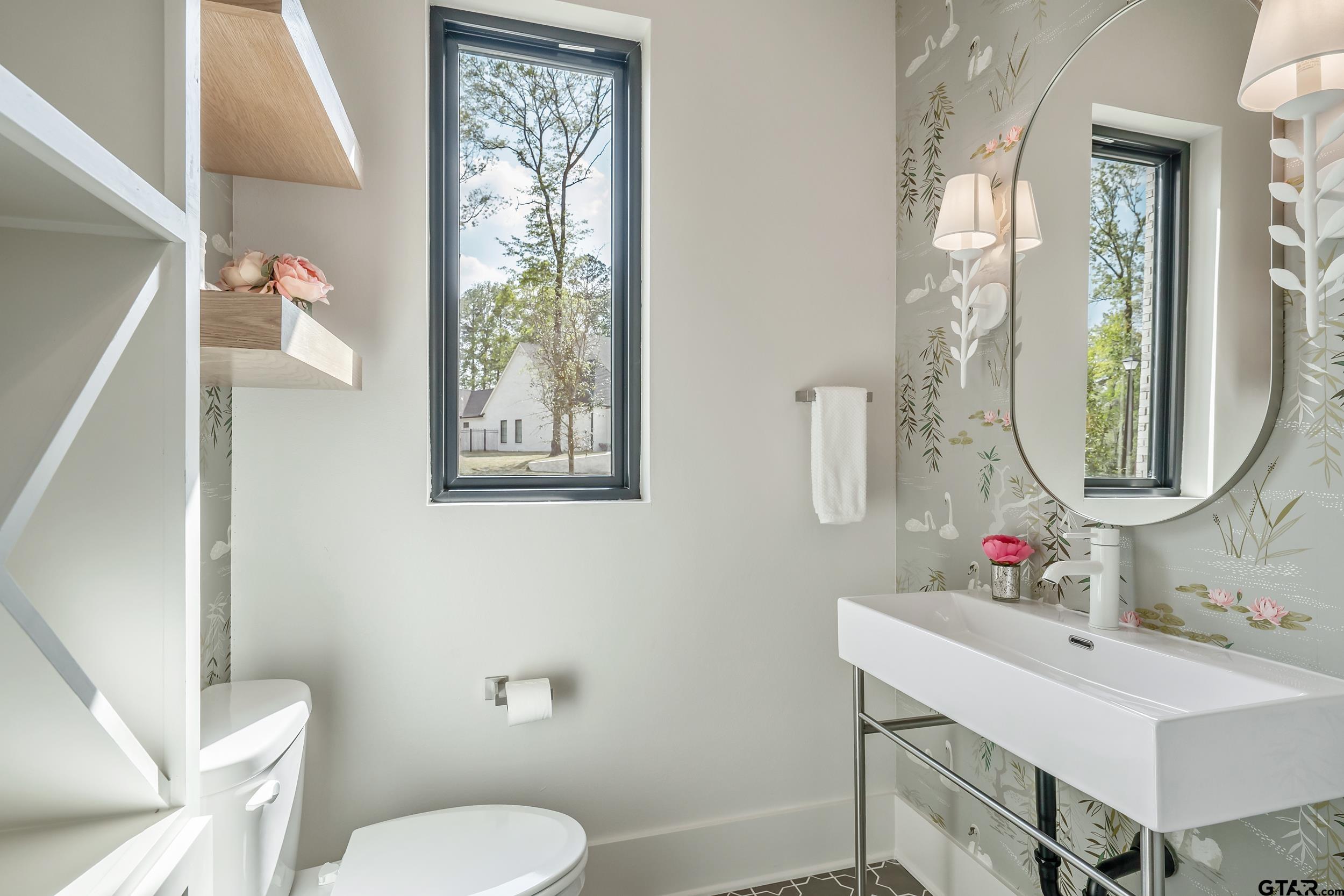 1409 Canopy Cv Court Tyler, TX 75703 - Photo 16 of 40 a bathroom with a toilet a sink and a mirror