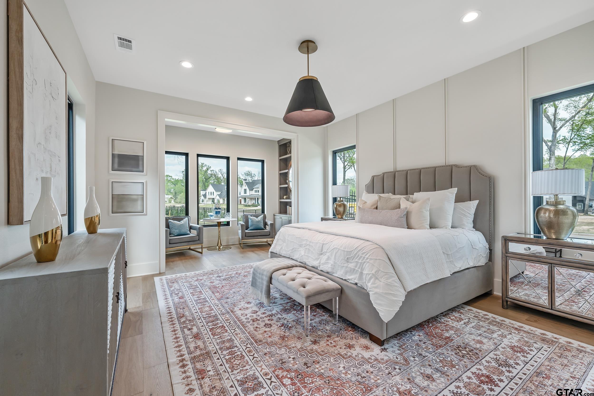 1409 Canopy Cv Court Tyler, TX 75703 - Photo 17 of 40 a spacious bedroom with a bed a table and large window