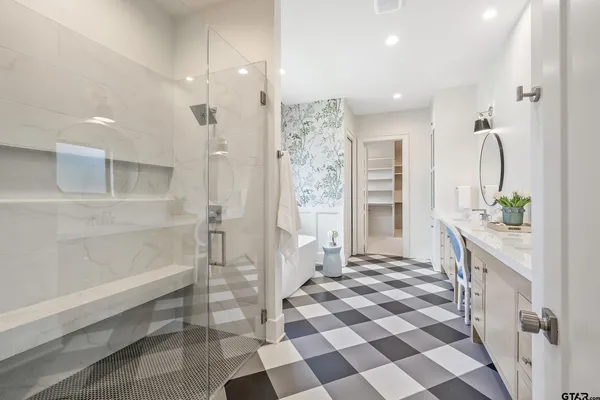 a bathroom with a sink a toilet and a mirror