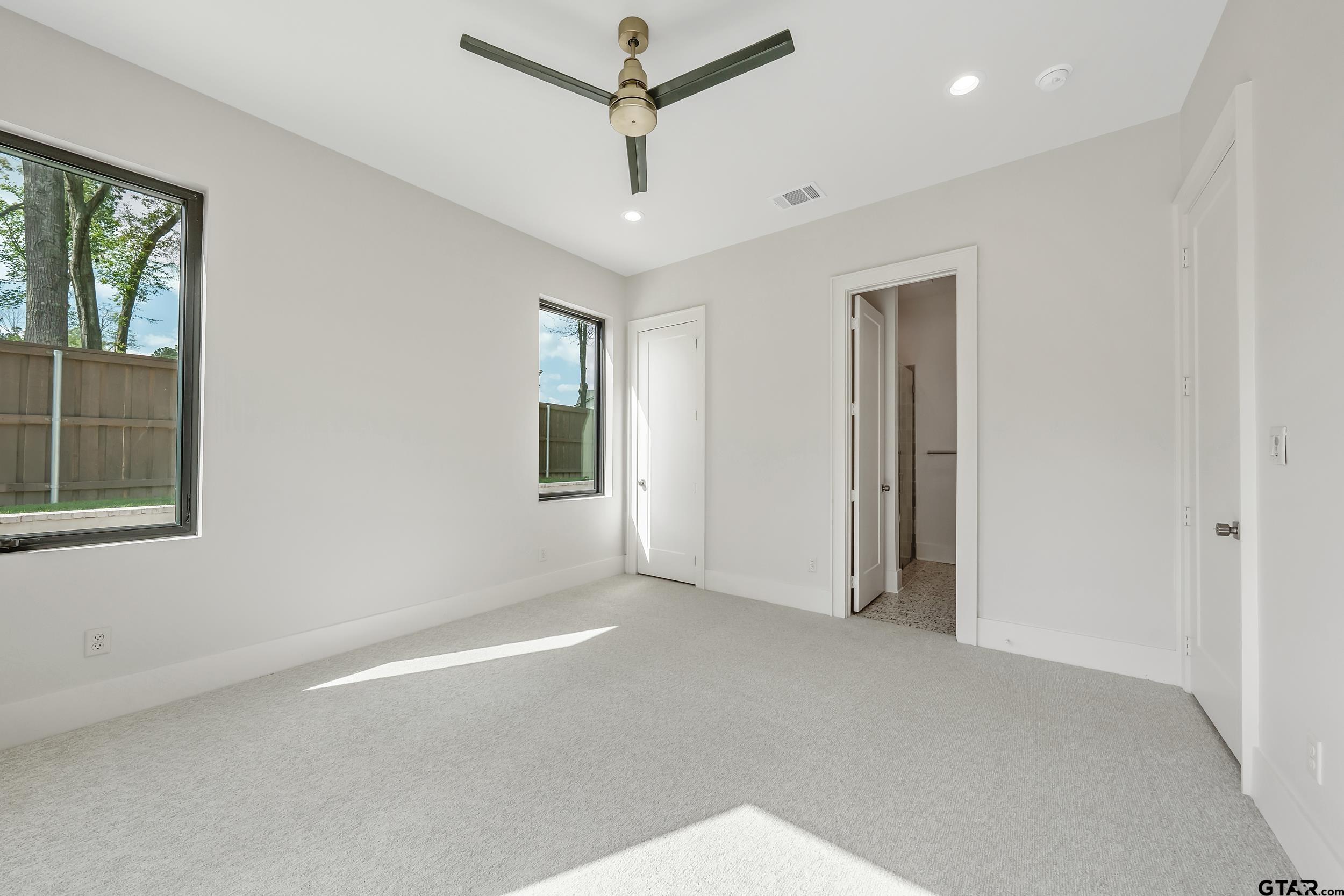 1409 Canopy Cv Court Tyler, TX 75703 - Photo 23 of 40 a view of a livingroom with a ceiling fan and window