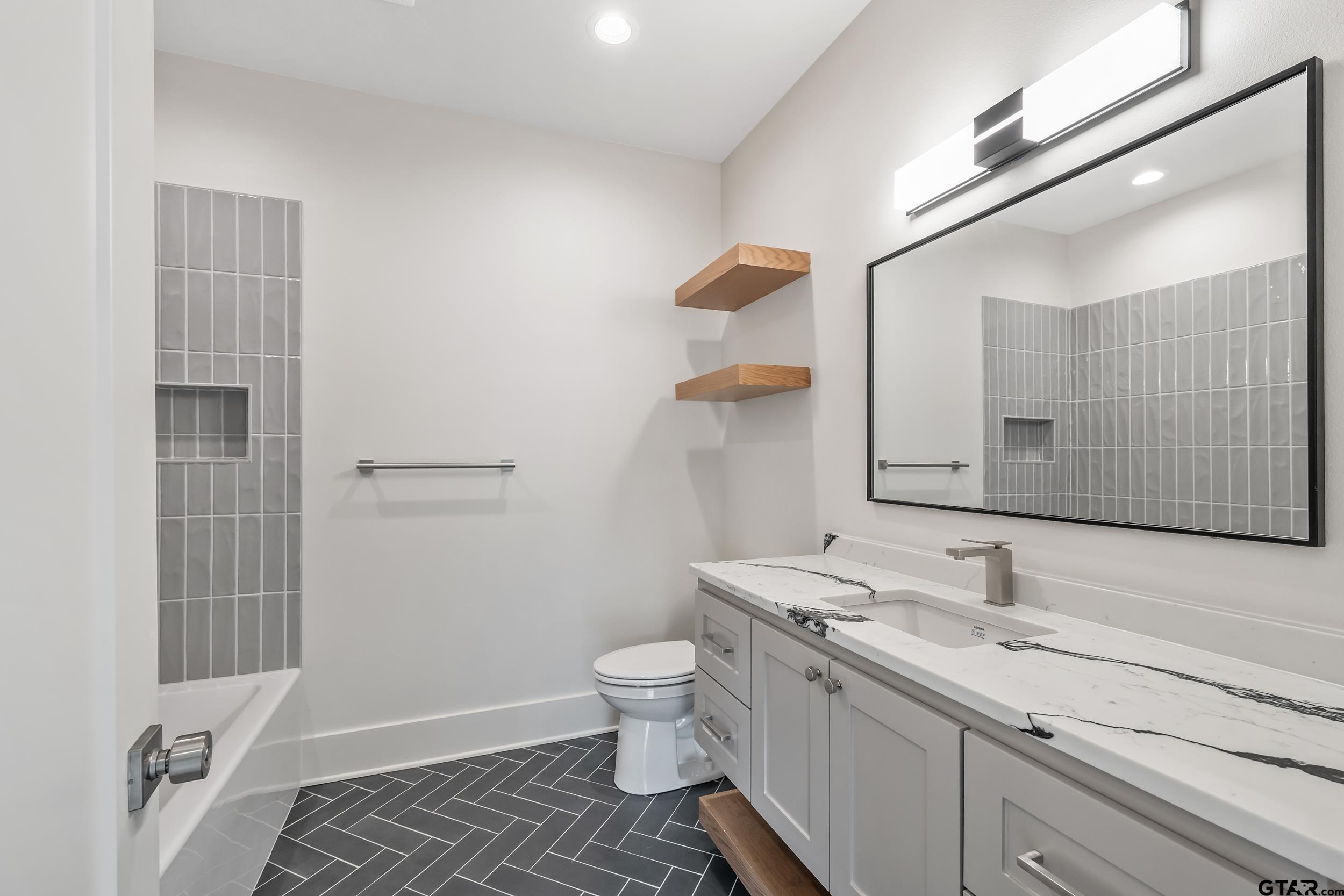 1409 Canopy Cv Court Tyler, TX 75703 - Photo 27 of 40 a bathroom with a sink a toilet and shower