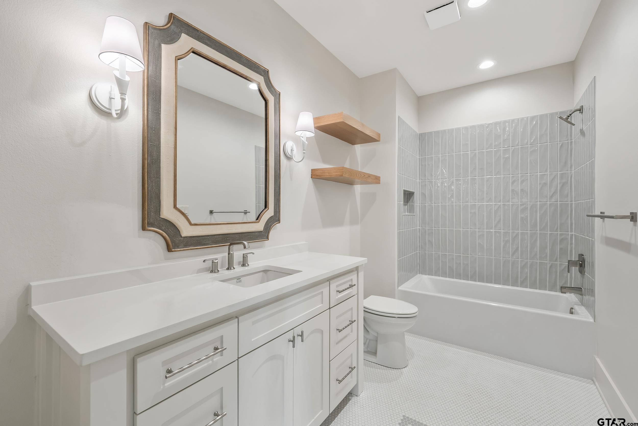 1409 Canopy Cv Court Tyler, TX 75703 - Photo 28 of 40 a bathroom with a sink a toilet and shower