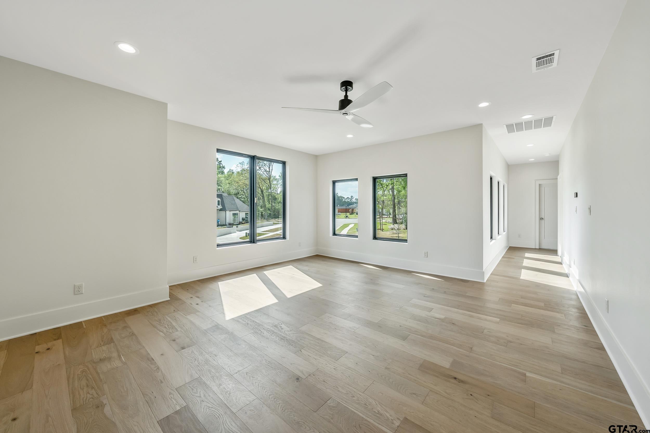 1409 Canopy Cv Court Tyler, TX 75703 - Photo 31 of 40 an empty room with wooden floor and windows