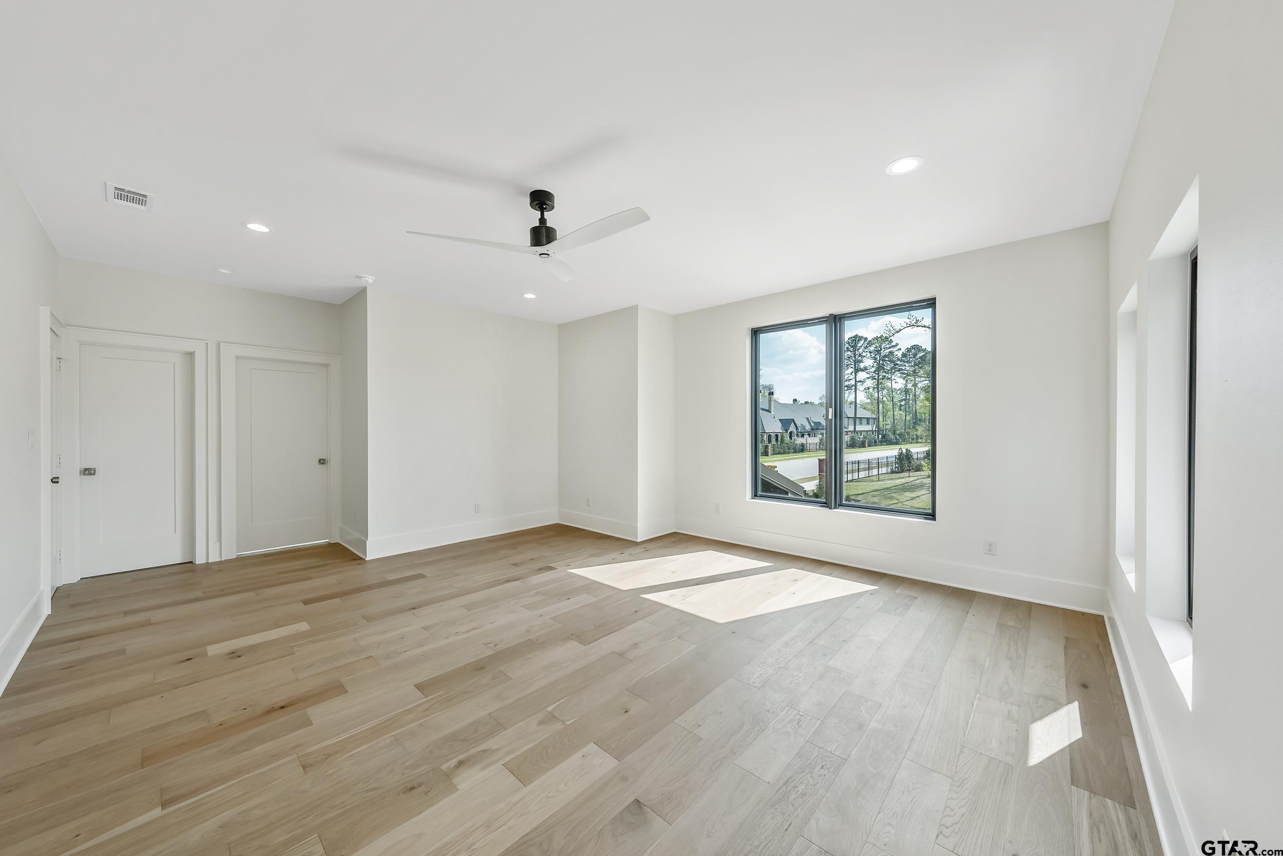 1409 Canopy Cv Court Tyler, TX 75703 - Photo 32 of 40 a view of an empty room with a window and wooden floor