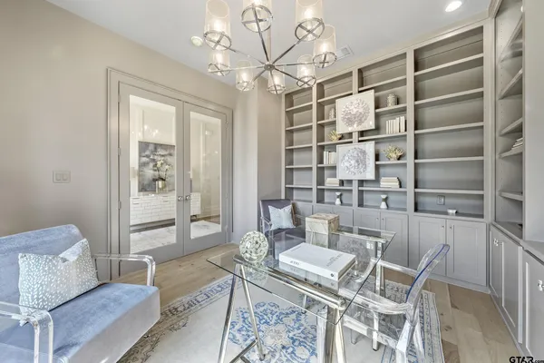 a view of a dining room with furniture and a chandelier