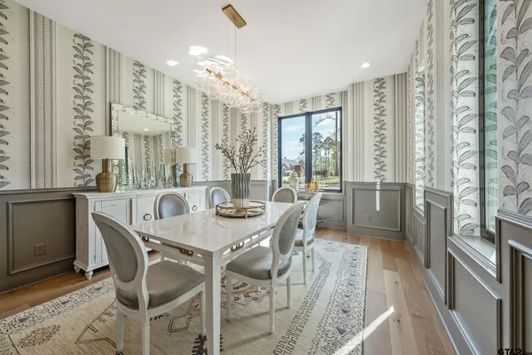 a large kitchen with kitchen island a large window in it