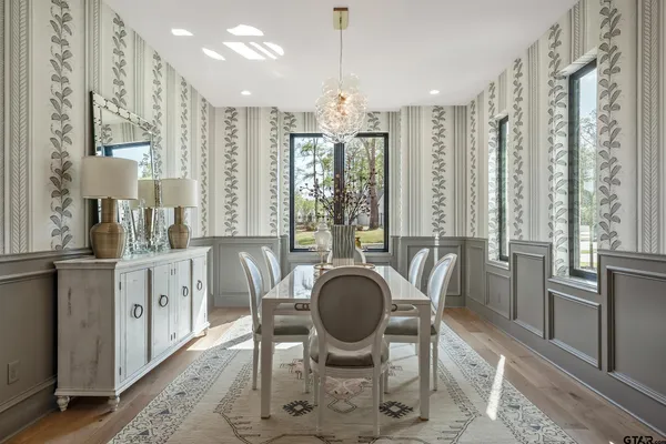 a living room with fireplace furniture and a large window