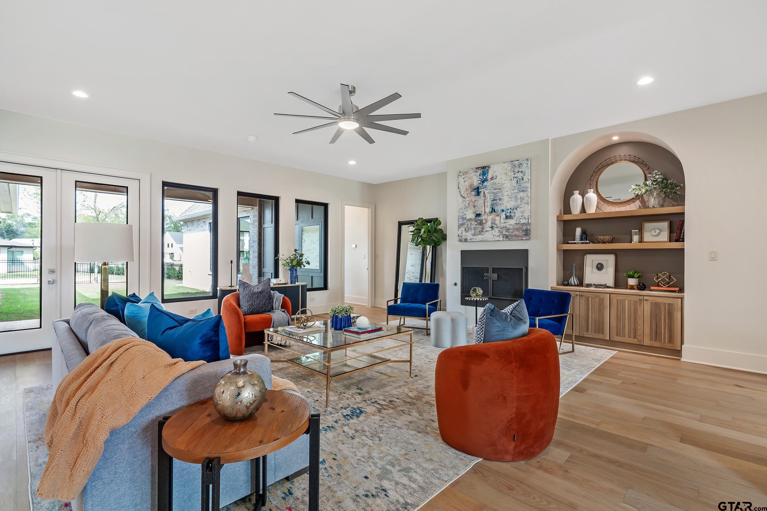 1409 Canopy Cv Court Tyler, TX 75703 - Photo 7 of 40 a living room with fireplace furniture and a large window