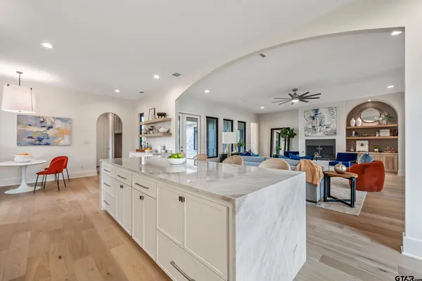 a bathroom with a granite countertop sink mirror and window