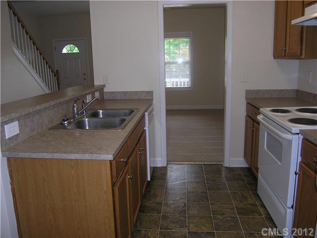 5767 Grassy Creek Road Denver, NC 28037 - Photo 2 of 11 a kitchen with a sink stove and cabinets