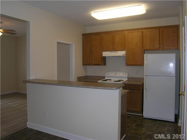 5767 Grassy Creek Road Denver, NC 28037 - Photo 3 of 11 a kitchen with a refrigerator and a stove