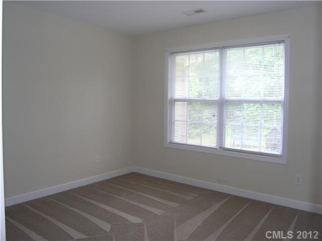5767 Grassy Creek Road Denver, NC 28037 - Photo 8 of 11 an empty room with a window