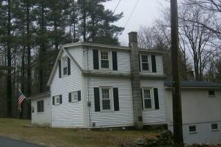 390 Chapel Road Savoy, MA 01256 - Photo 2 of 2 a front view of a house with a yard