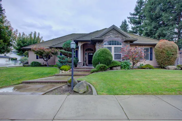a front view of house with yard and green space