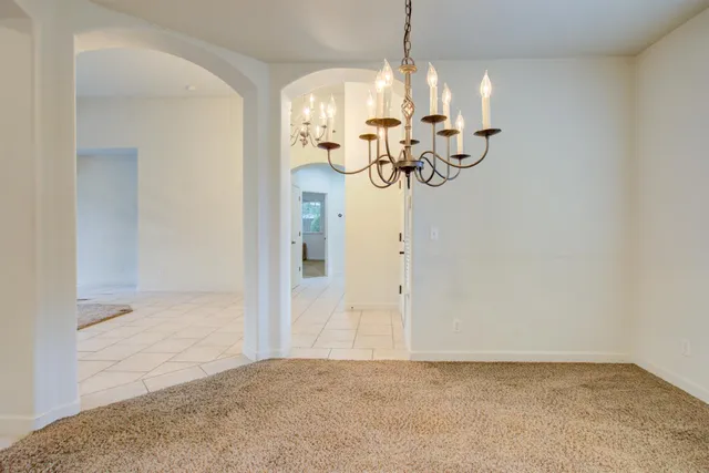 a view of a chandelier fan and kitchen view