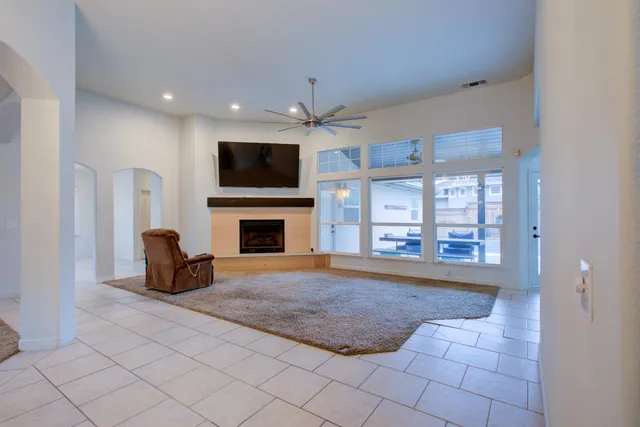 a living room with furniture a flat screen tv and a fireplace