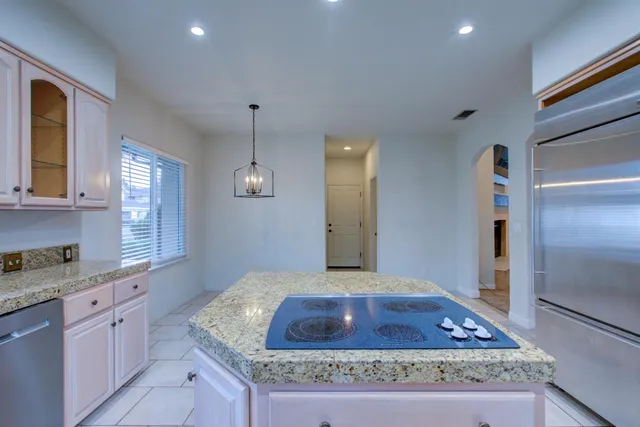 a kitchen with sink stove and refrigerator