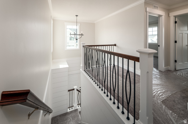 8797 Green Way, Unit 3 Sandy, UT 84094 - Photo 5 of 12 Stairs with crown molding and a chandelier