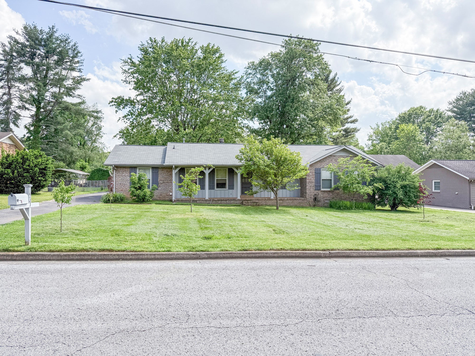 1431 Avon Road Murfreesboro, TN 37129 - Photo 2 of 4 a front view of a house with a yard and trees