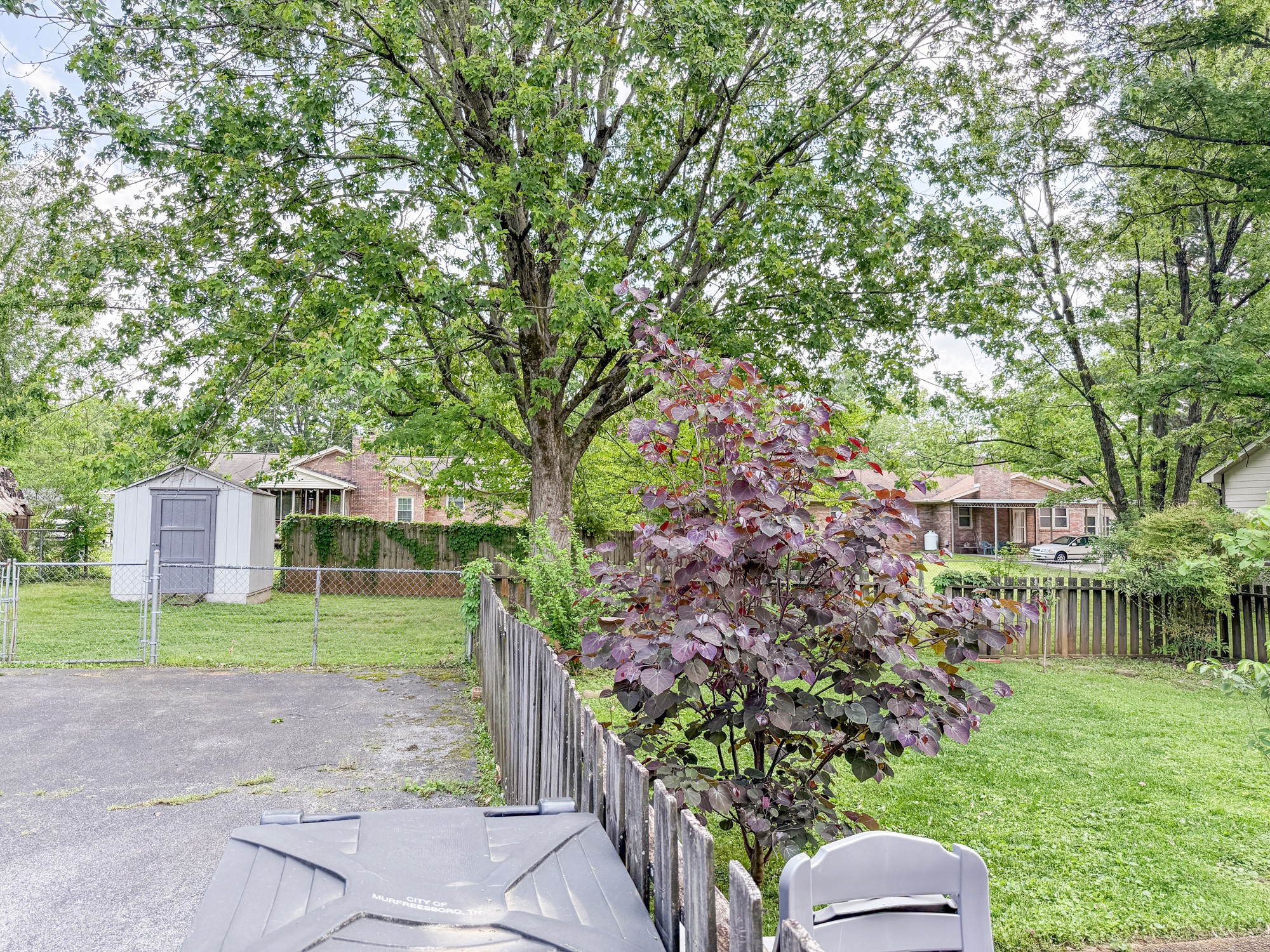 1431 Avon Road Murfreesboro, TN 37129 - Photo 4 of 4 a front view of a house with a yard and a garden
