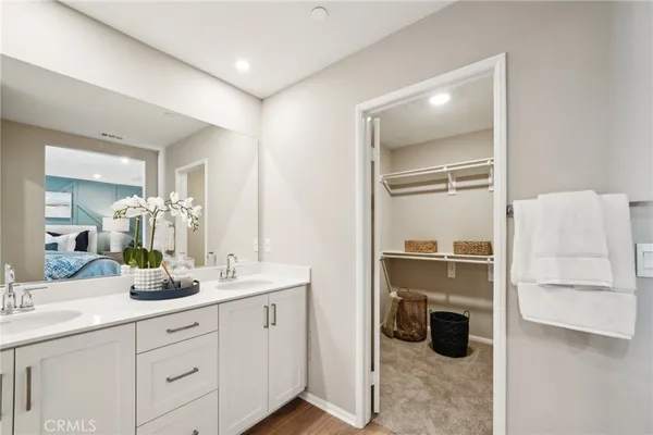 a bathroom with a double vanity sink toilet and shower