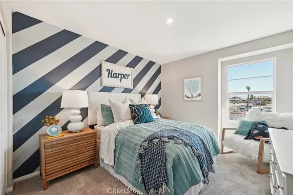 a bedroom with a bed and a potted plant