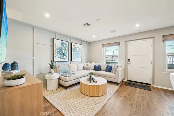 a living room with furniture and wooden floor