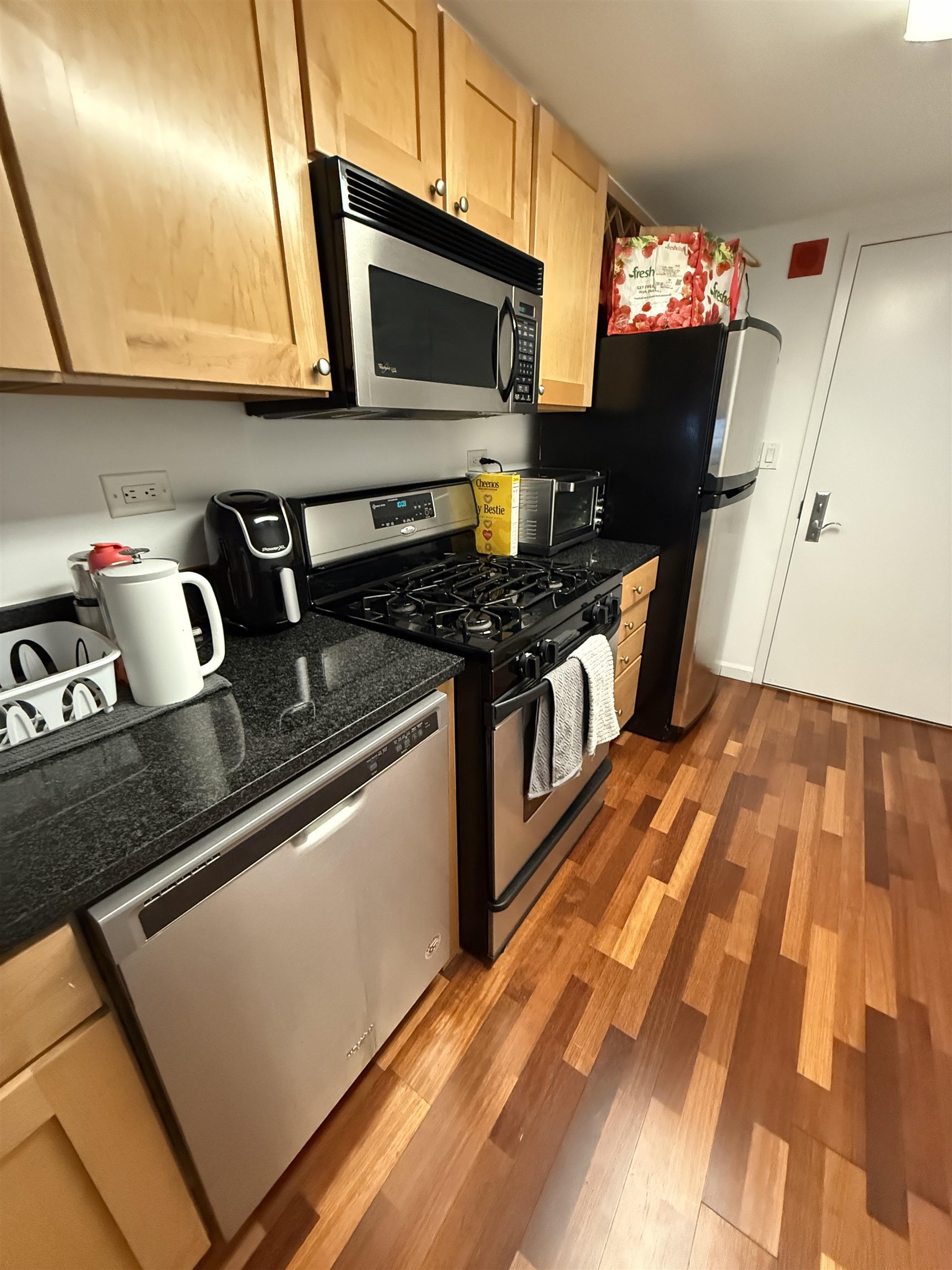700 1st Street, Unit 2R Hoboken, NJ 07030 - Photo 4 of 13 a kitchen with stainless steel appliances granite countertop a stove a sink and a microwave
