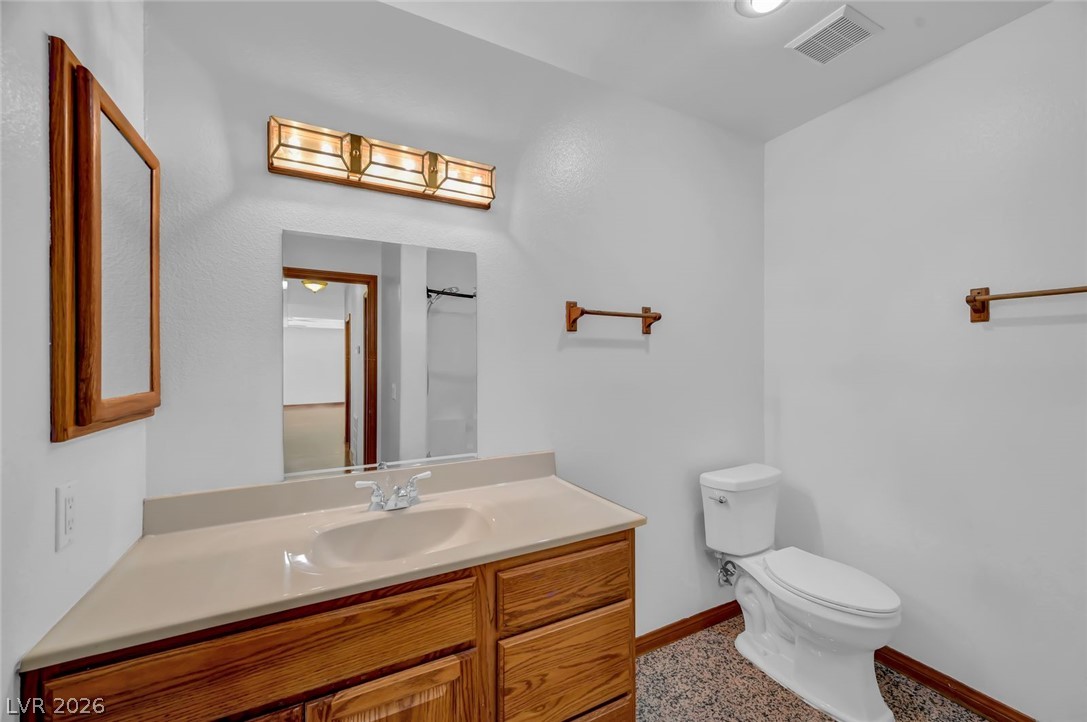 640 North Racetrack Road Henderson, NV 89015 - Photo 37 of 65 A well-lit bathroom features a functional vanity and practical flooring, offering comfort and ease.