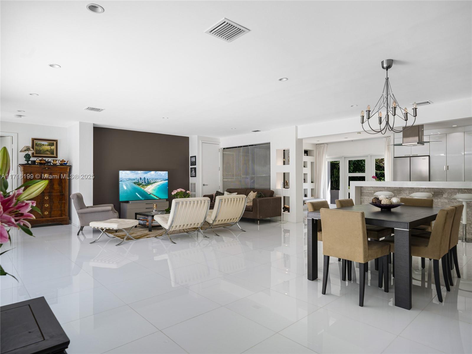 203 Ridgewood Road Coral Gables, FL 33133 - Photo 14 of 46 a living room with furniture a flat screen tv and a table