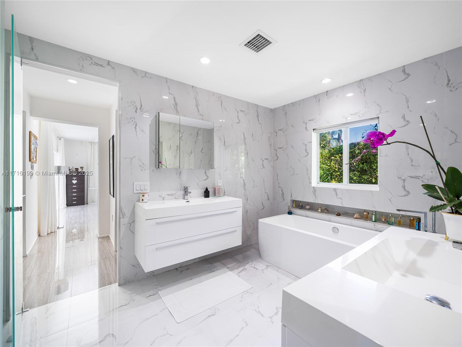 203 Ridgewood Road Coral Gables, FL 33133 - Photo 19 of 46 a white bath tub sitting next to a white sink