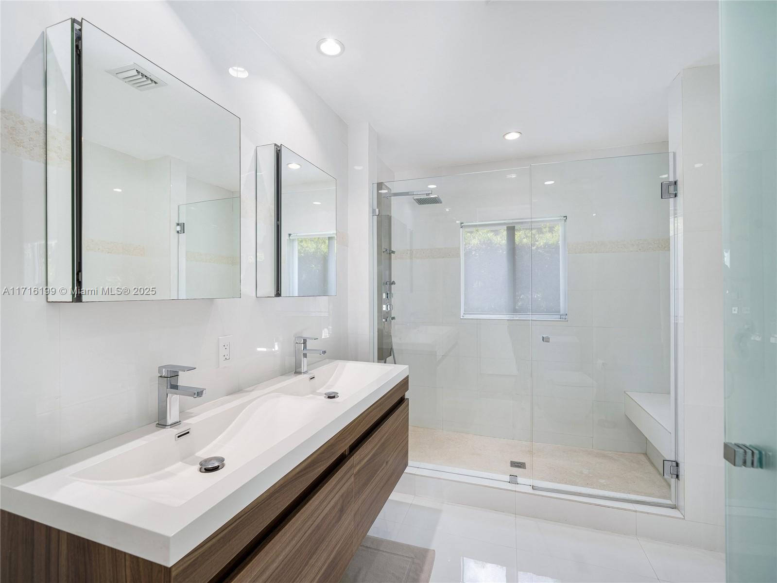 203 Ridgewood Road Coral Gables, FL 33133 - Photo 24 of 46 a bathroom with a bathtub a mirror a sink and vanity