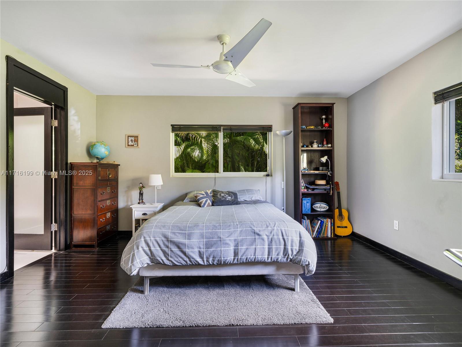 203 Ridgewood Road Coral Gables, FL 33133 - Photo 25 of 46 a bedroom with a bed and wooden floor